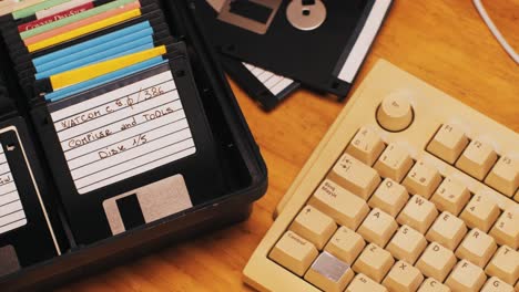 vintage computer setup with floppy disks and keyboard