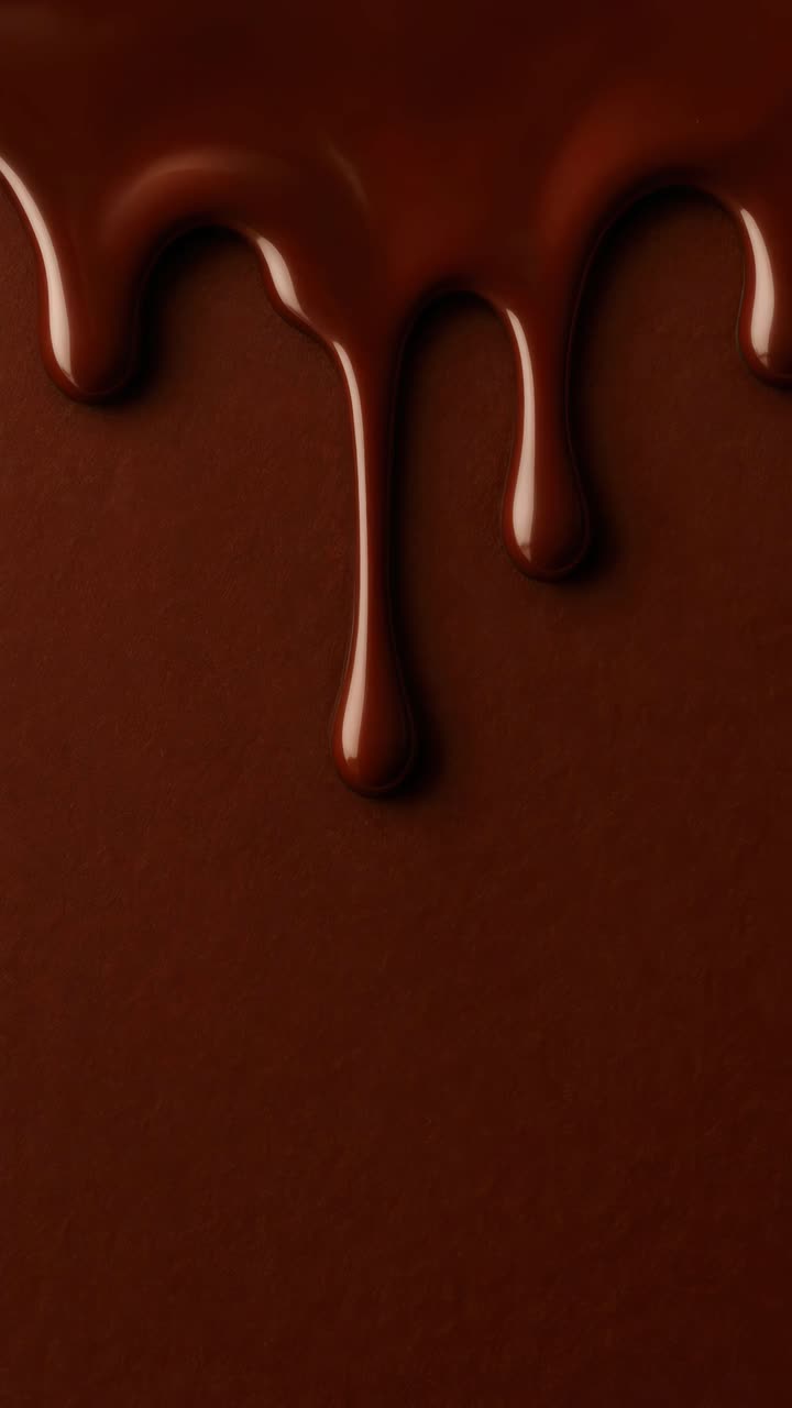 Close-up of rich, melted chocolate dripping down, captured from a high angle