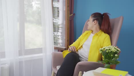 Happy-and-peaceful-woman.-She-is-sitting-in-front-of-the-window.