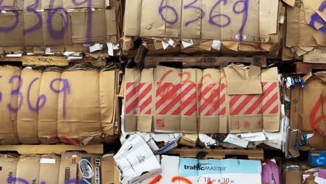 bundles of bulk cardboard banded for recycling from retail stores on wood pallets