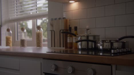 kitchen work surface with a cooking hob and jars of pasta