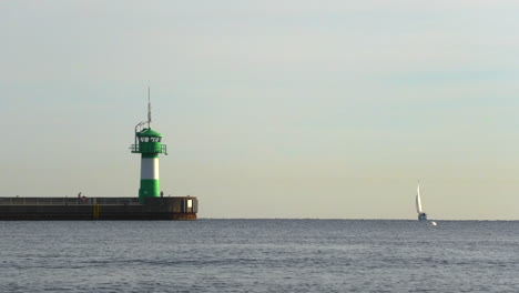 the-green-lighthouse-of-Luebeck-Travemuende-stands-at-the-entrance-of-the-harbor