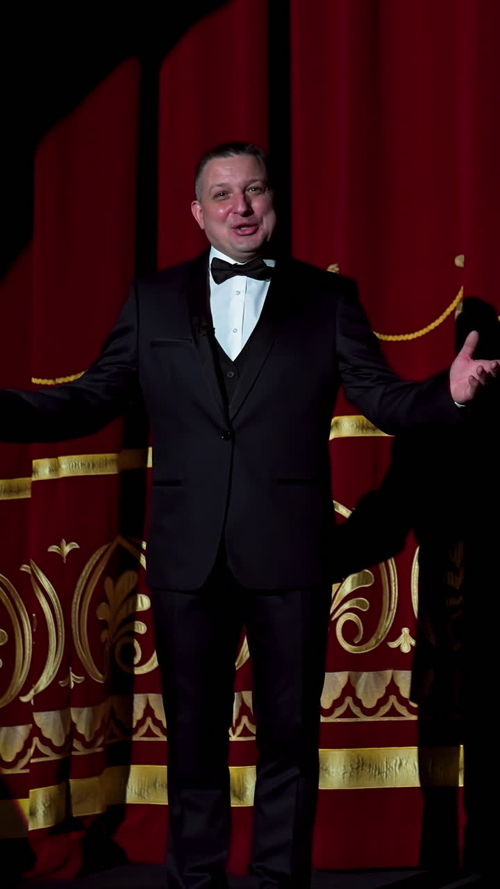 Senior man in costume on stage in darkness. Actor man in selective light on stage during the performance in the theater. Vertical video