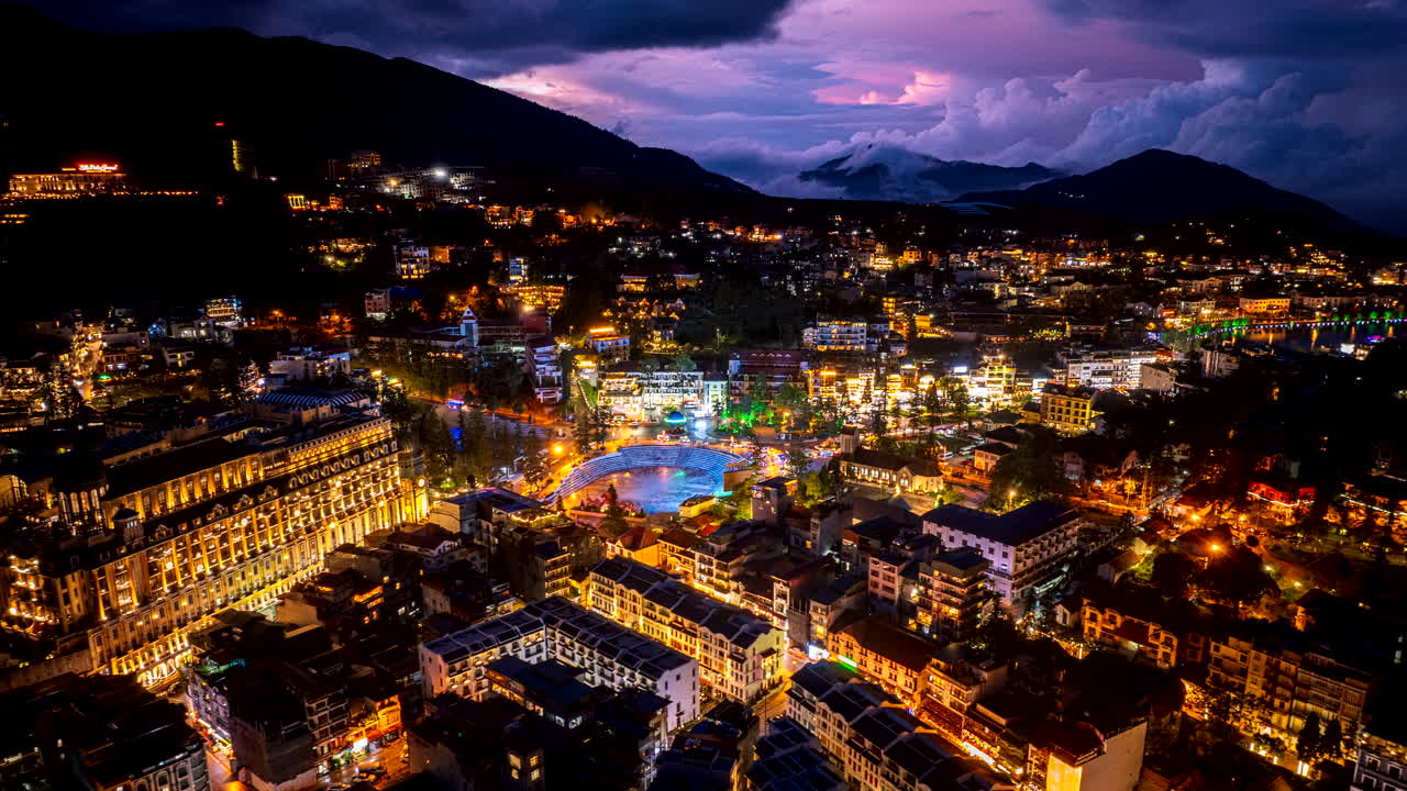 Incredible twilight drone hyperlapse over illuminated Sapa alpine town, Vietnam
