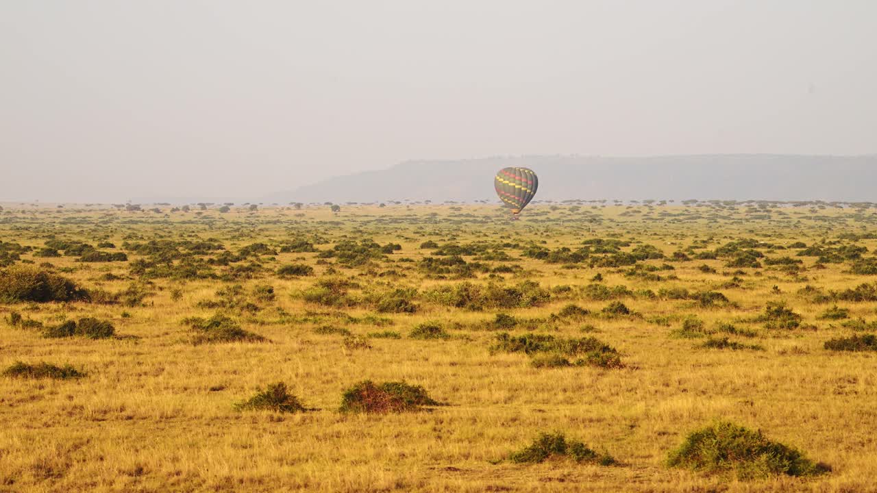 Hot Air Balloon Flight Ride, High View Flying Over Maasai Mara Landscape in Africa, Aerial Shot of Beautiful African Savannah Scenery at Sunrise in Amazing Travel Experience Luxury Ballooning Trip
