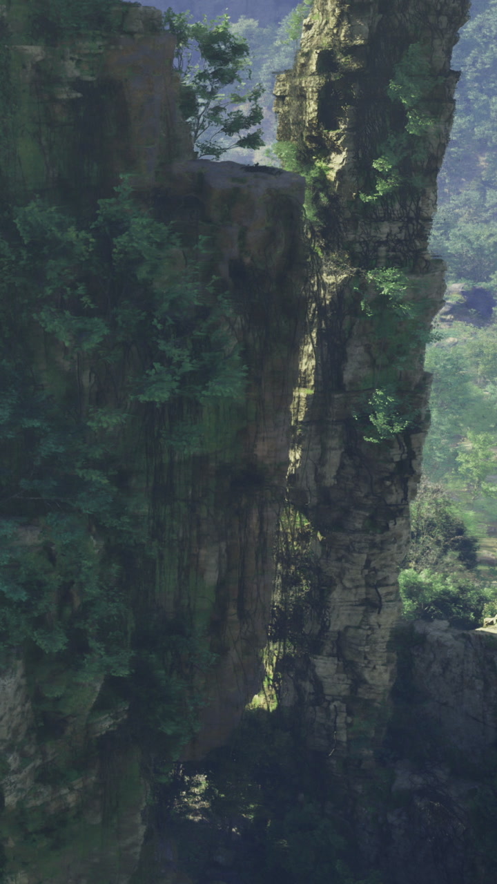 Tall rock formation with green vegetation near a forested area