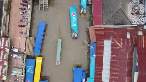 2 boats squeeze through narrow canal at floating market, thailand