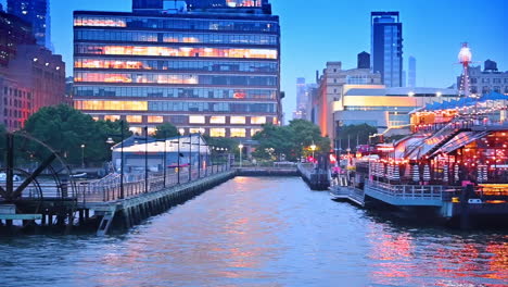 waterfront of modern new york with beautiful piers and boats. river tour by the hudson river at dusk time