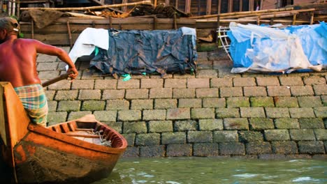bedeni people (water gypsy) boats and tents by the river in dhaka, bangladesh
