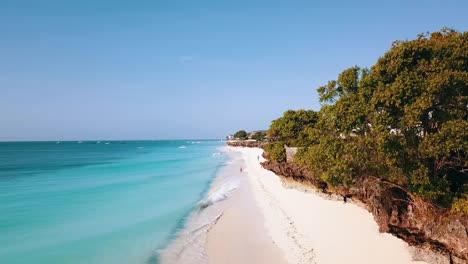 Amazing-aerial-flight-over-coast-line-white-sand-beach-crystal-clear-turquoise-water