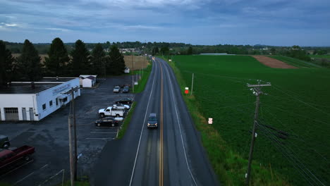 Drone-view-of-cars-on-wet-rural-road