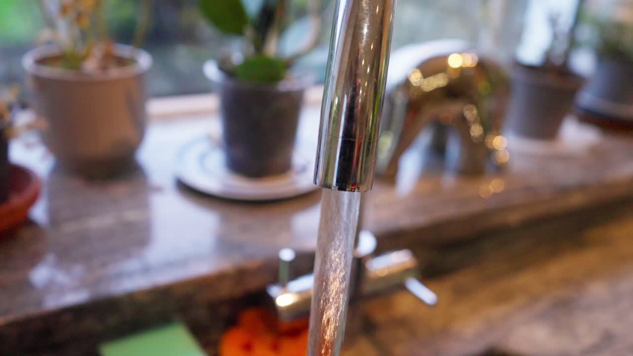 Home kitchen, running water and potted plants brings sense of calm and clarity