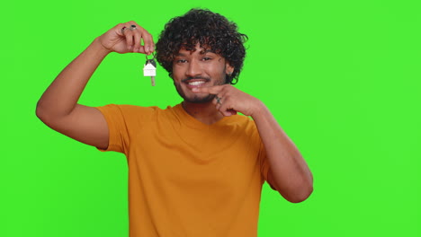 Young-indian-man-real-estate-agent-showing-keys-of-new-home-house-apartment,-buying-renting-property