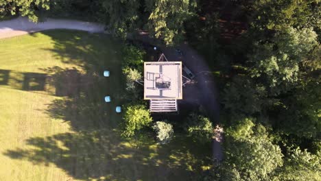 aerial drone shot above pfannenstiel observation tower flying backwards and tilting up revealing lake zürich in the background