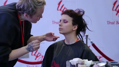 makeup artist applying makeup to model