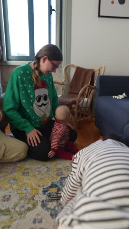 family with baby interacting in living room