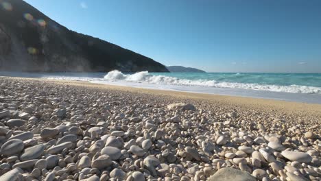 pebble beach with beautiful blue sea and white waves