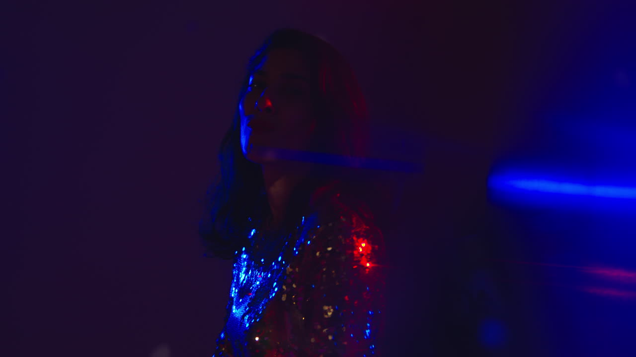 Close Up Of Woman In Nightclub Bar Or Disco Dancing And Having Fun Looking In Camera