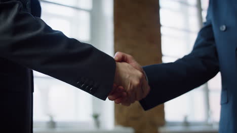 closeup men shaking hands at office meeting. handshaking on negotiation concept