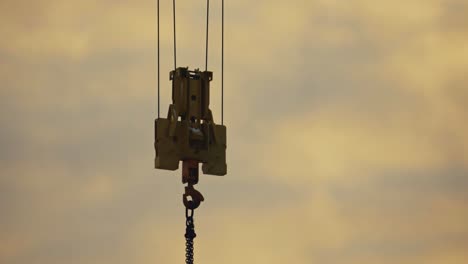 close up of construction crane hanging in the air, hard work lifestyle