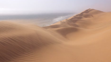 high winds blow across the amazing sand dunes of the namib desert along the skeleton coast of namibia