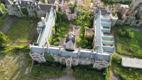 haunted denbigh lunatic asylum, north wales, aerial rocket up vertically, sunny afternoon