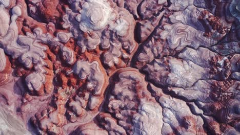 textured background of uneven surface of sandstone cliffs in sunlight