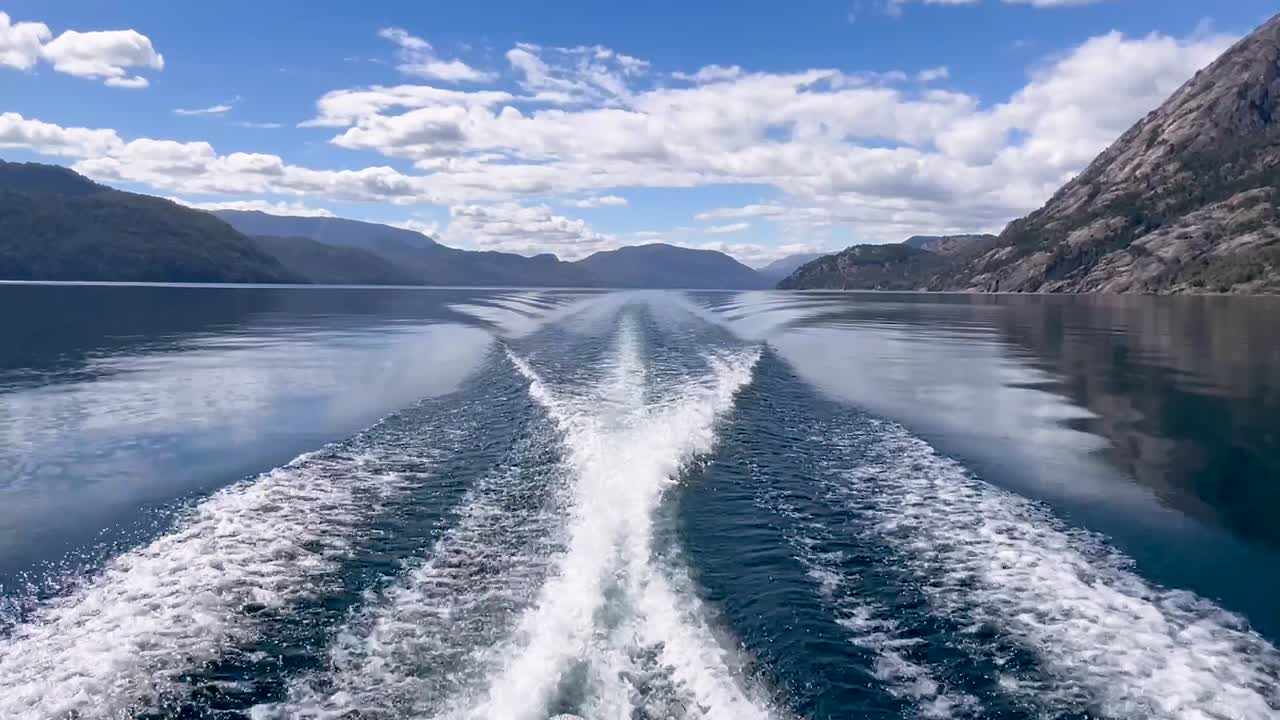 Lago Lacar Quila Quina in Argentina, captured from a boat's wake on a serene lake
