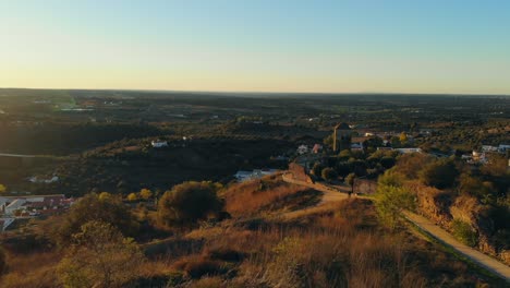 drone shot of a tower on a hill in the nature