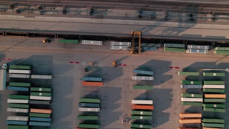 unique-aerial-of-container-handler-driving-above-lined-up-containers