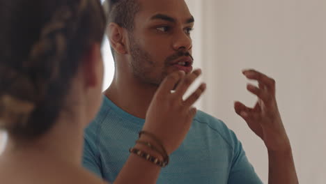 portrait attractive young hispanic man chatting to woman friend in dance class discussing healthy fitness lifestyle sharing training tips enjoying conversation in studio