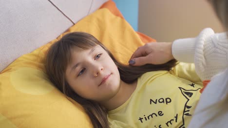 mom prepares her cute little daughter for sleep, strokes her hair, loves it.