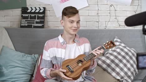 teenage blogger filming ukulele tutorial