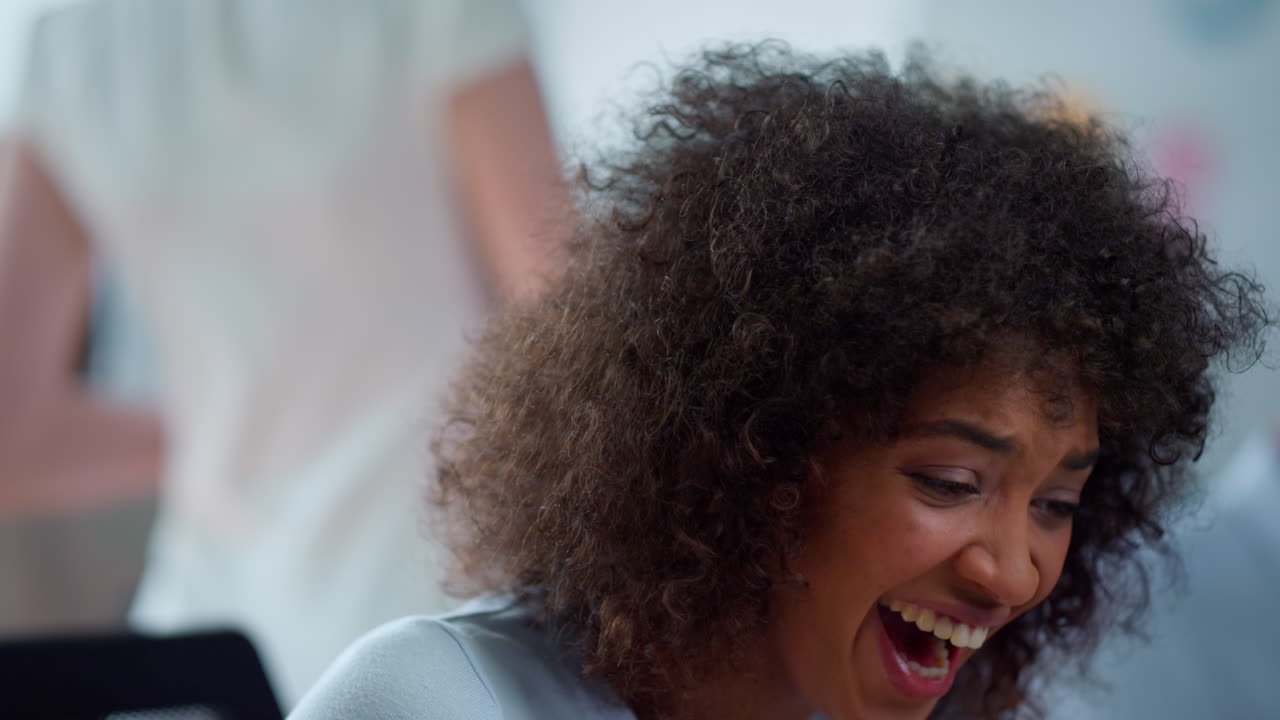 Closeup smiling businesswoman sitting at workplace