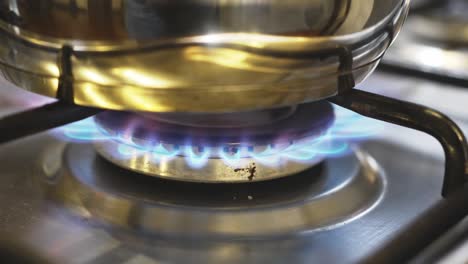 saucepan in a fire on the burner of the gas stove. the energy crisis.