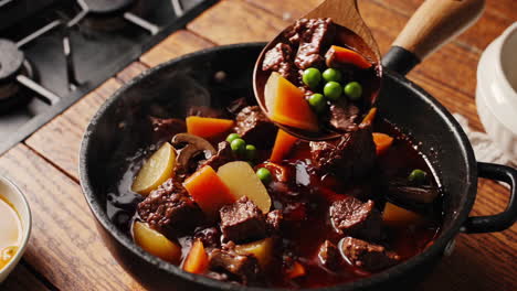 hearty beef stew with vegetables cooking in a pot