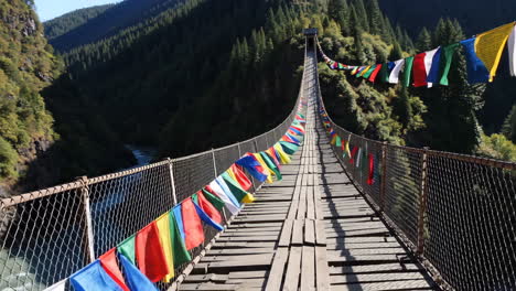 Colorful Prayer Flags on a Mountain Suspension Bridge