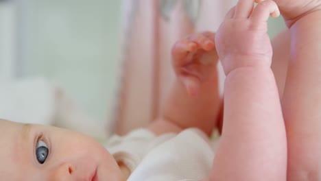 Baby-looking-at-camera-on-baby-bed-at-home-4k