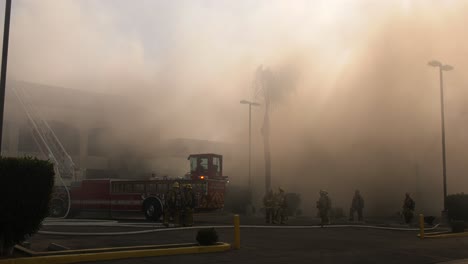 smoky skies as firefighters battle structure fire