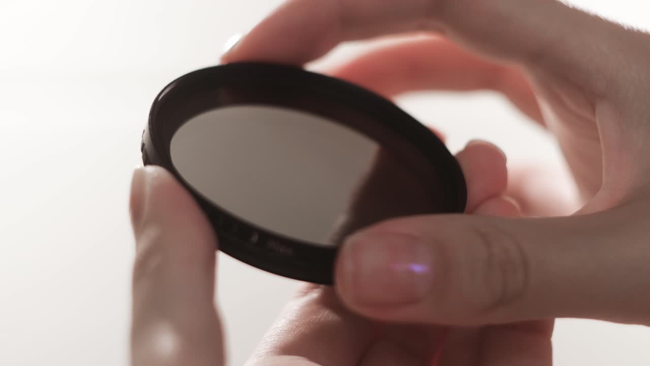 Hands holding a neutral density filter