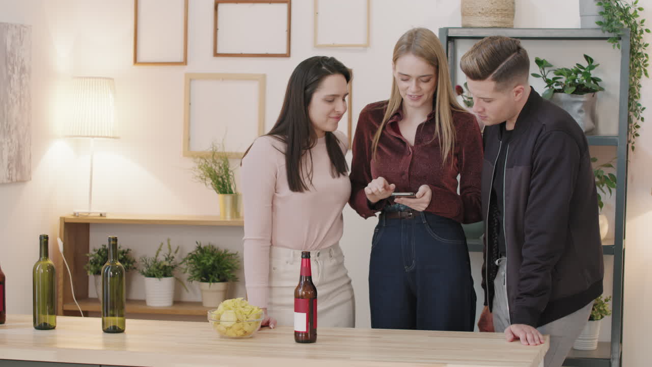 Young People Looking at Something on Mobile Phone