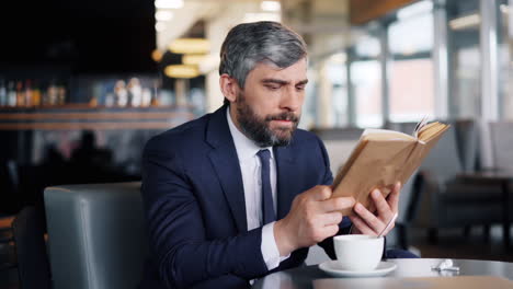 businessman reading in a cafe