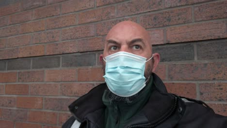 male guard in uniform wearing protective corona virus medical ppe mask