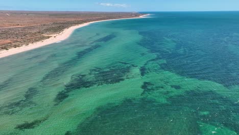 Drone flyby shot of turquoise bay with long stretched beach in Exmounth, australia.