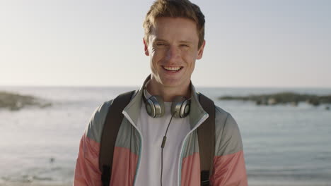 portrait of young attractive man laughing cheerful on beautiful sunny beach