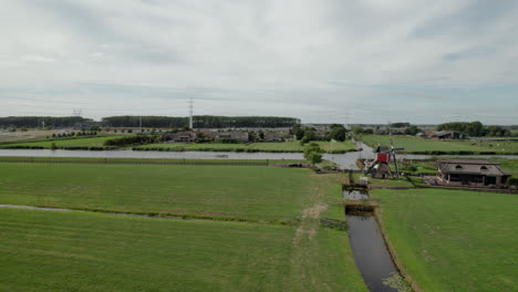 Fly-Over-Doesmolen-And-Kalkmolen-Wind-Mills-In-Dutch-Polders-In-Hoogmade,-Netherlands