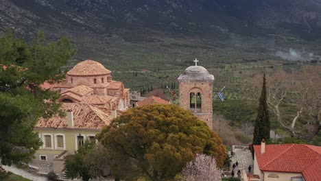 a cinematic tilt reveal aerial shot of hosios loukas holy monastery