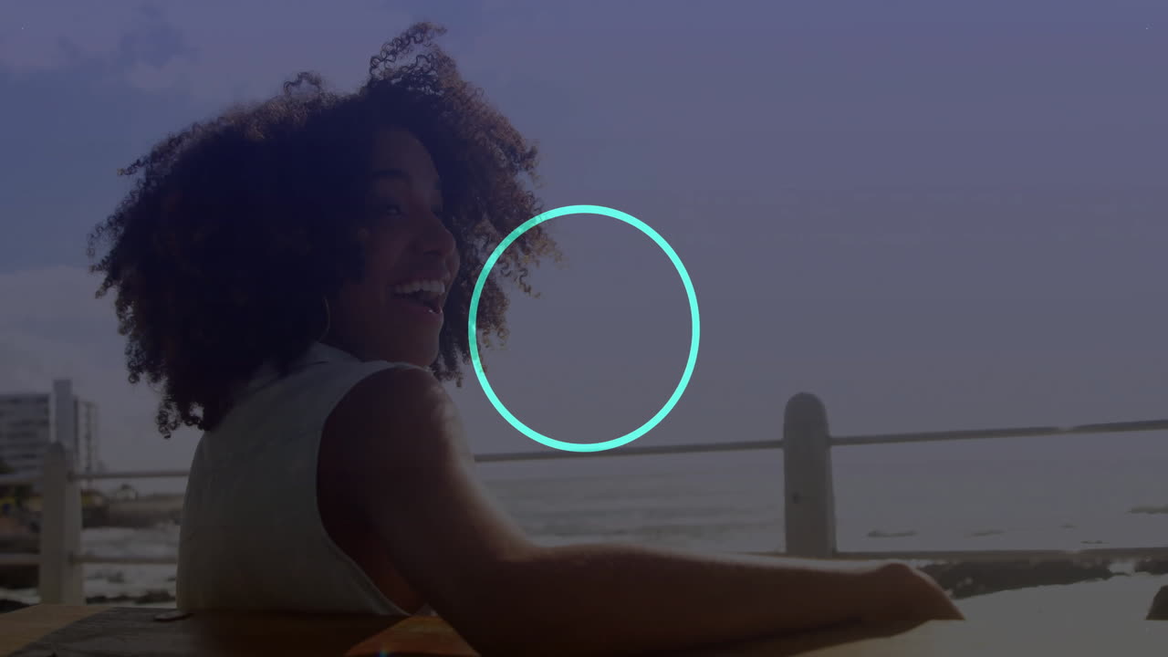 Smiling woman sitting outdoors with blue dot pattern animation overlay