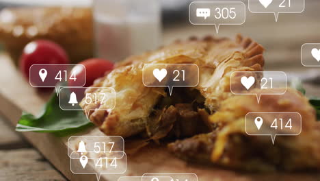 On wooden board, savory pie with animation of social media notifications floating