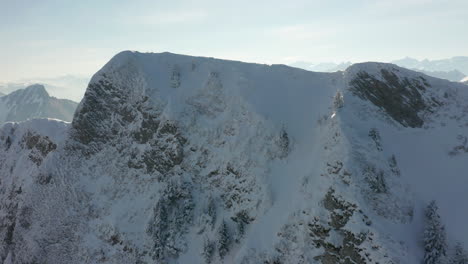 Drone-flying-over-mountain-summit-and-reveal-small-tunnel-systems-on-top